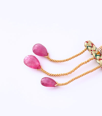 Close‑up of Ruby teardrop stones arranged to highlight brilliance and clarity.