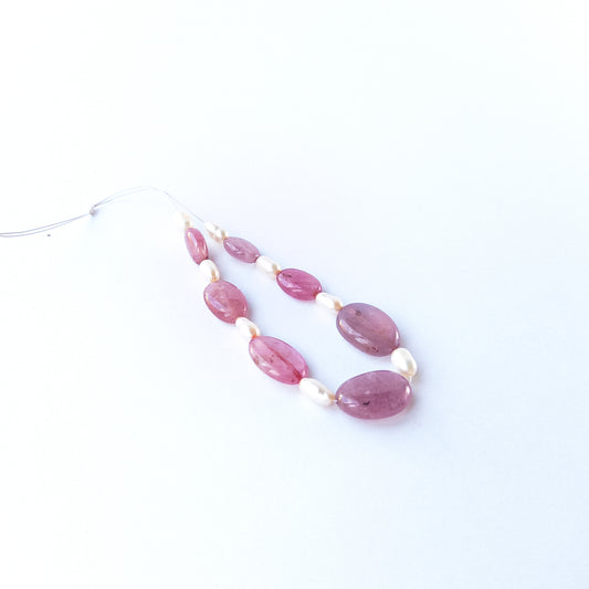 Seven Ruby smooth oval beads displaying rich red tones, sized 9.2–14.7mm × 6.6–10.9mm.