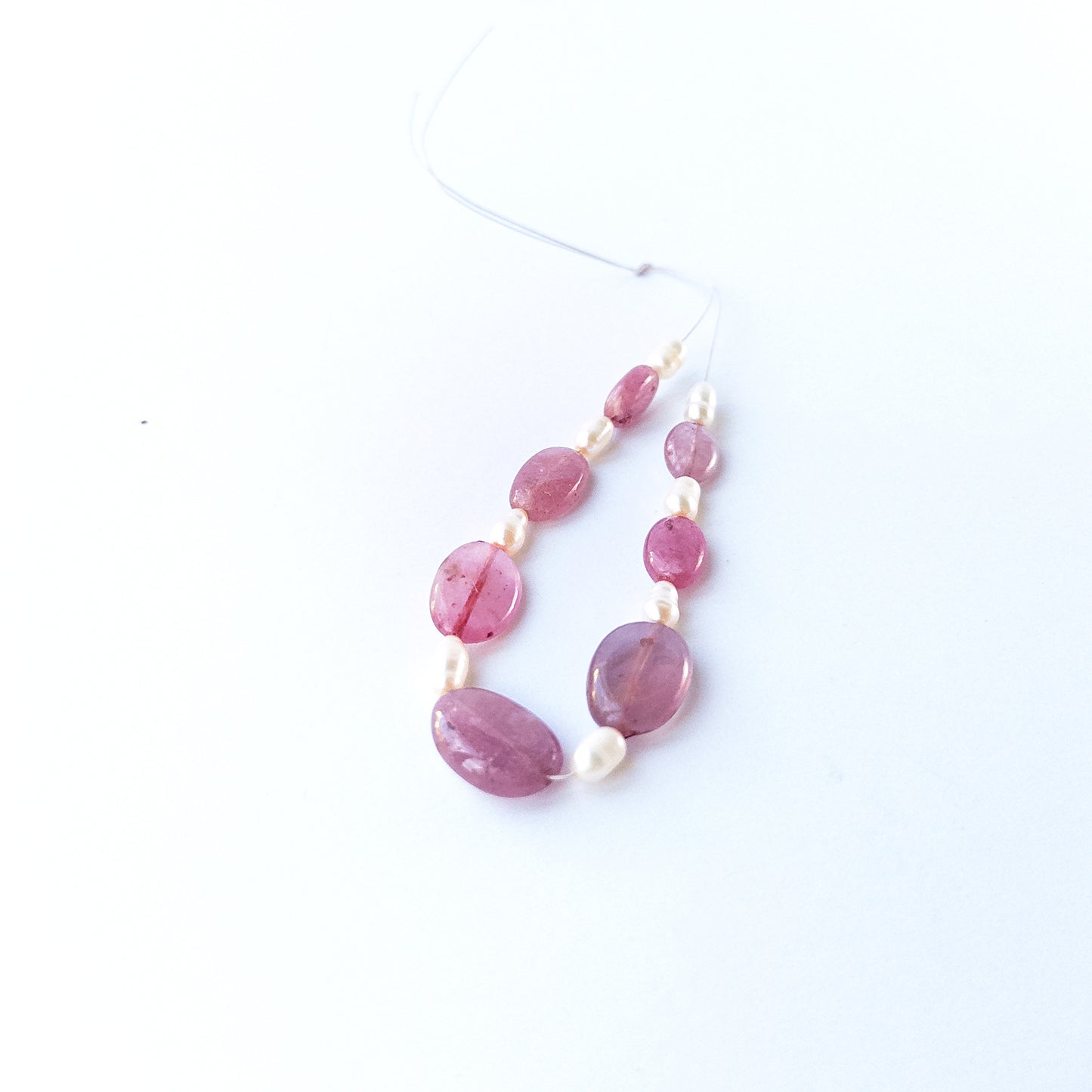 Eight baroque freshwater oval pearls 3.6–4.2mm with natural lustre and organic shapes.