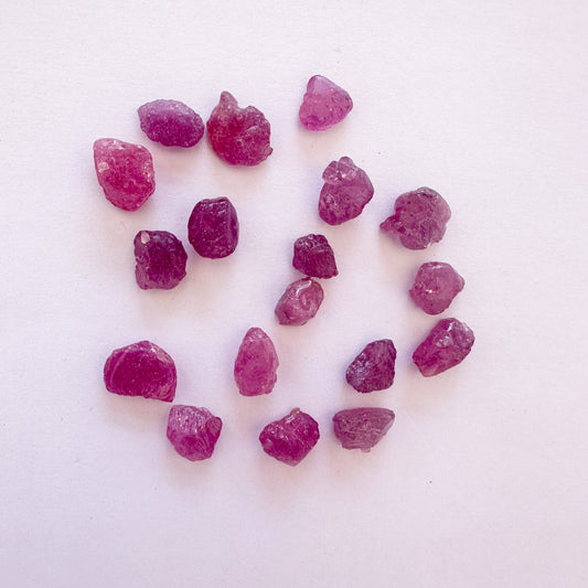 Loose rough ruby gemstones with vivid red tones and natural texture, sized 7.5–9.5mm.