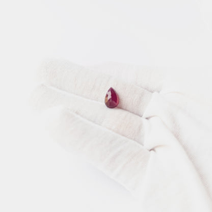 Close‑up of Ruby pear cabochon showing polished surface, natural inclusions and high‑quality gemstone shine.