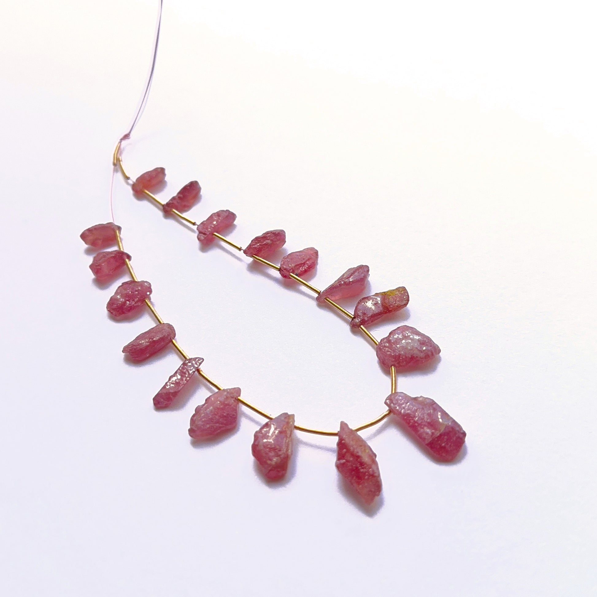 Stone beads in raw ruby showcasing raw texture and rich colour. 