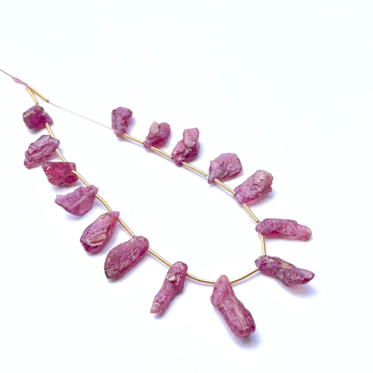 Ruby rough gemstone pieces showing deep red tones and raw texture for handmade jewellery.