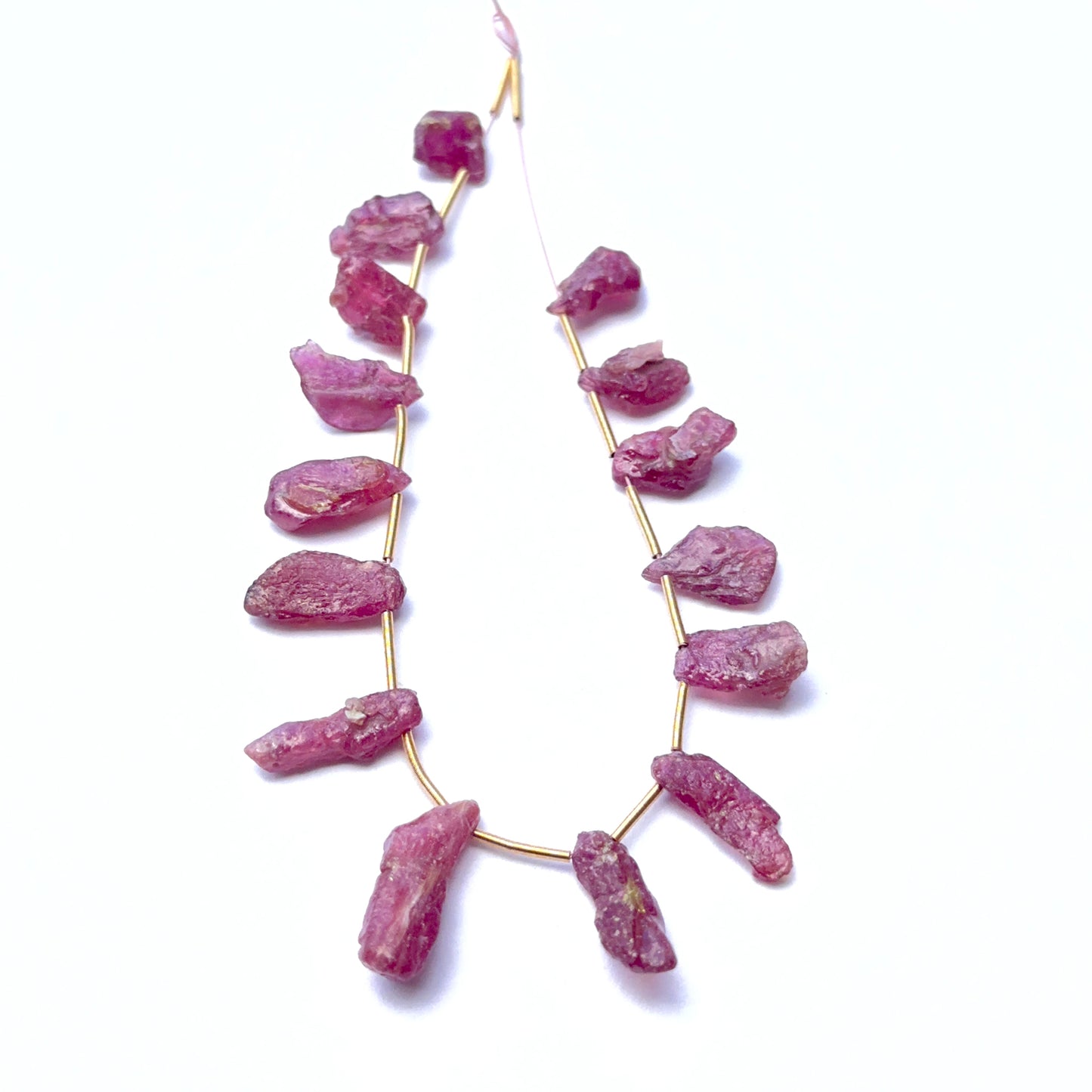 Close‑up of ruby rough stones highlighting their organic shape and rich crimson colour.