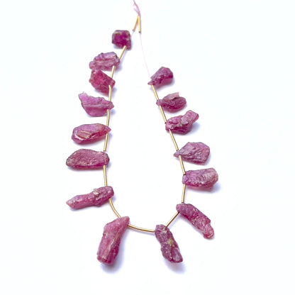 Close‑up of ruby rough stones highlighting their organic shape and rich crimson colour.