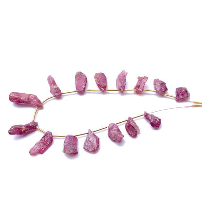 Ruby rough stones arranged neatly to showcase gemstone quality and handcrafted appeal.