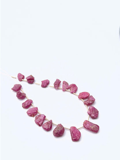 Ruby rough beads arranged neatly to showcase gemstone quality and earthy handcrafted appeal.