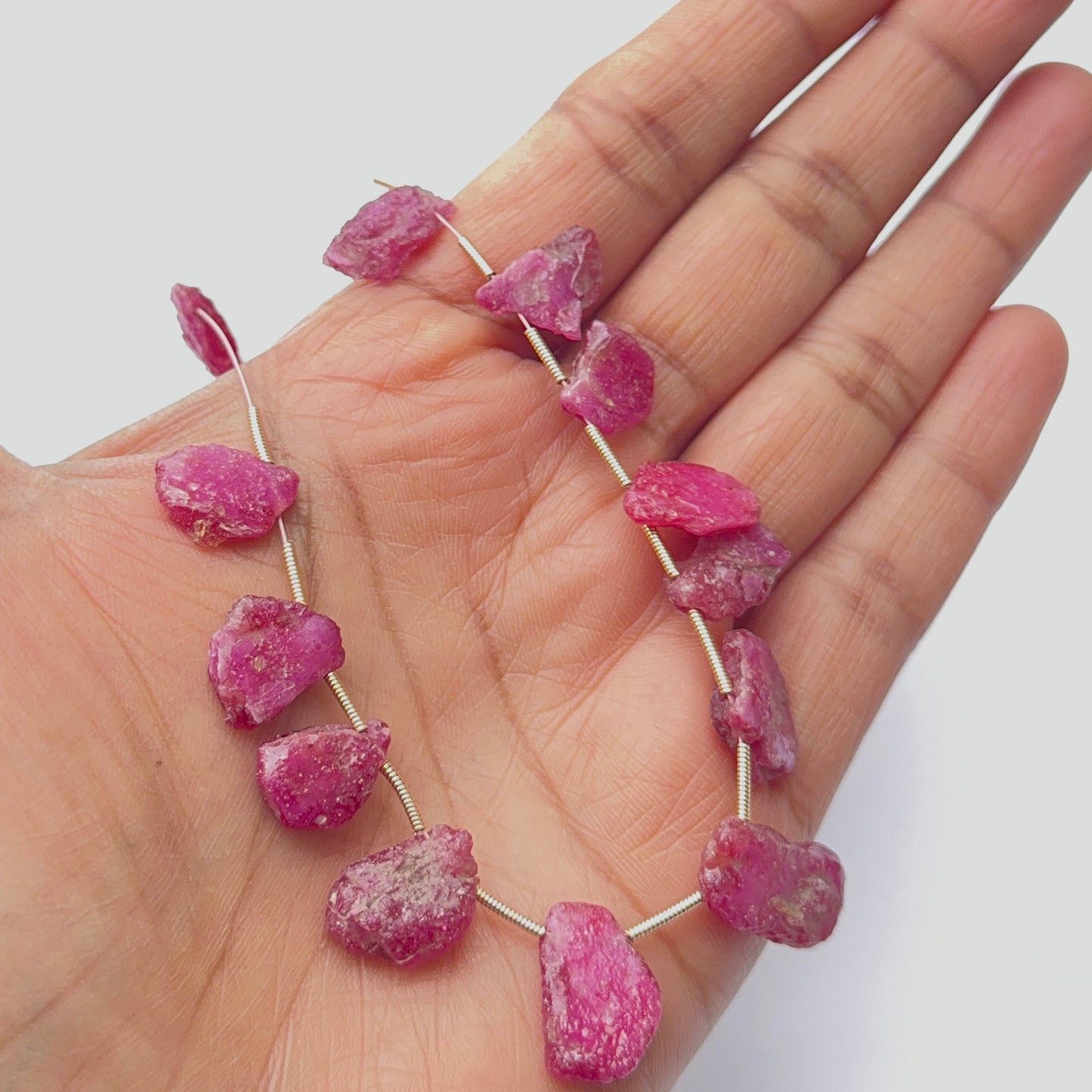 Raw ruby stone beads displayed with visible texture, ideal for gemstone beads in jewellery making.