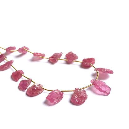 Raw ruby beads displayed with visible texture ideal for gemstone beads in jewellery making.