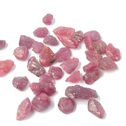 Close view of Ruby rough pieces arranged together, highlighting rich colour and handmade jewellery component quality.