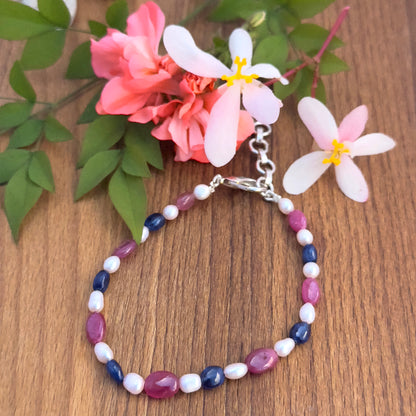 Natural gemstone beads bracelet with vibrant Ruby, Sapphire, and lustrous Pearls in oval cut.