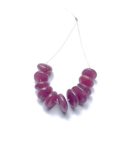 Vibrant ruby stone beads with a glossy shine, highlighting their smooth disc cut and handmade jewellery components.