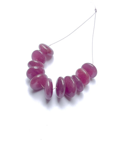 Ruby smooth disc beads arranged in a rich red strand, showcasing gemstone beads for DIY jewellery.