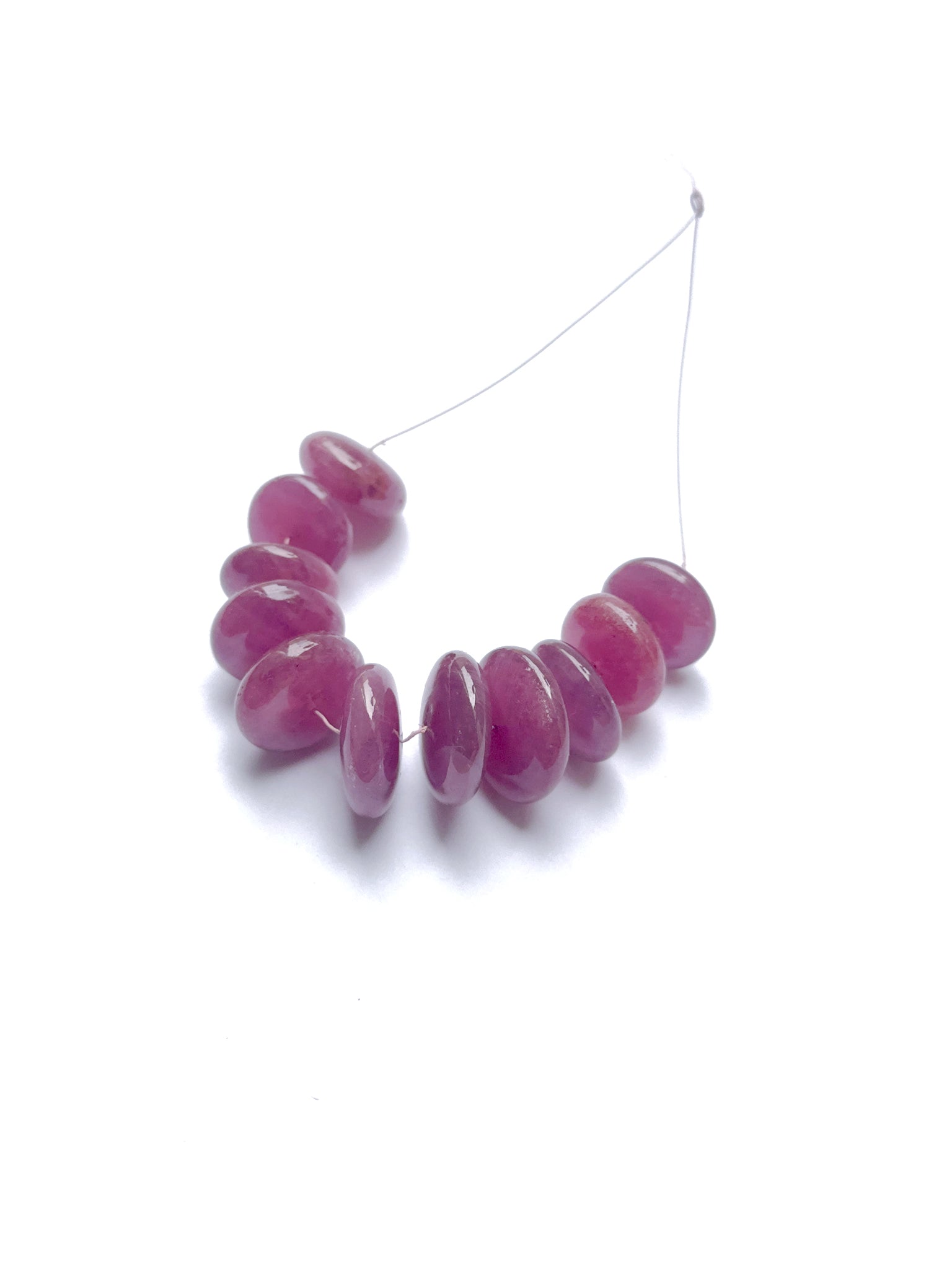 Deep red ruby disc beads aligned in a uniform strand, ideal gemstone beads for elegant jewellery designs.