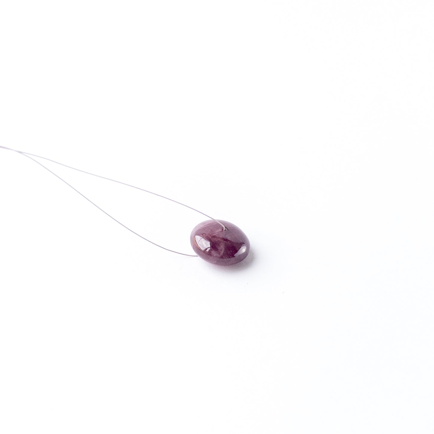 Genuine Ruby cabochon disc showing rich red tone, glossy surface and premium handmade jewellery quality.
