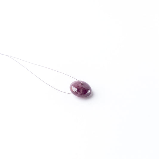 Genuine Ruby cabochon disc showing rich red tone, glossy surface and premium handmade jewellery quality.