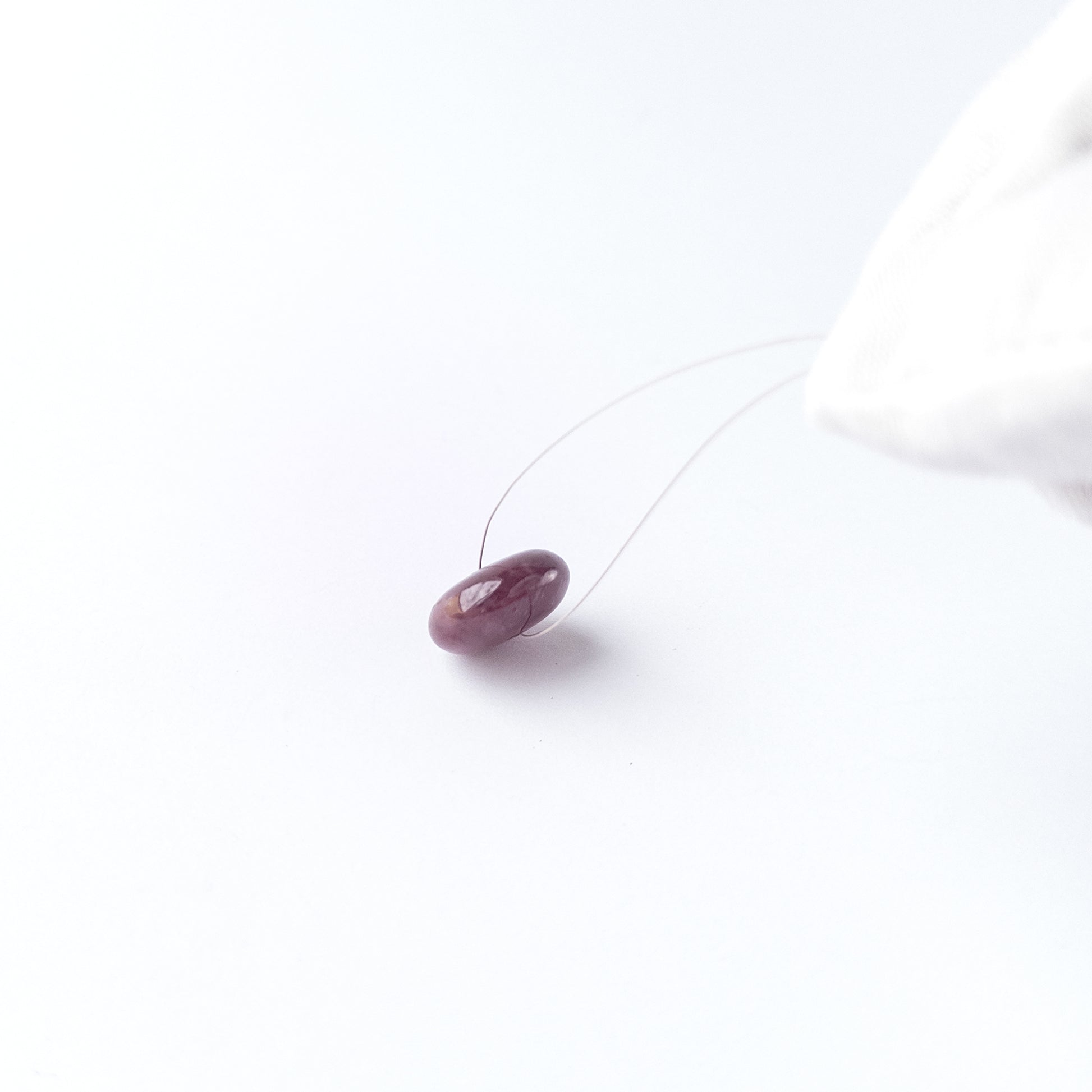 Handmade jewellery components featuring Ruby disc cabochon with polished finish and vibrant red hue.