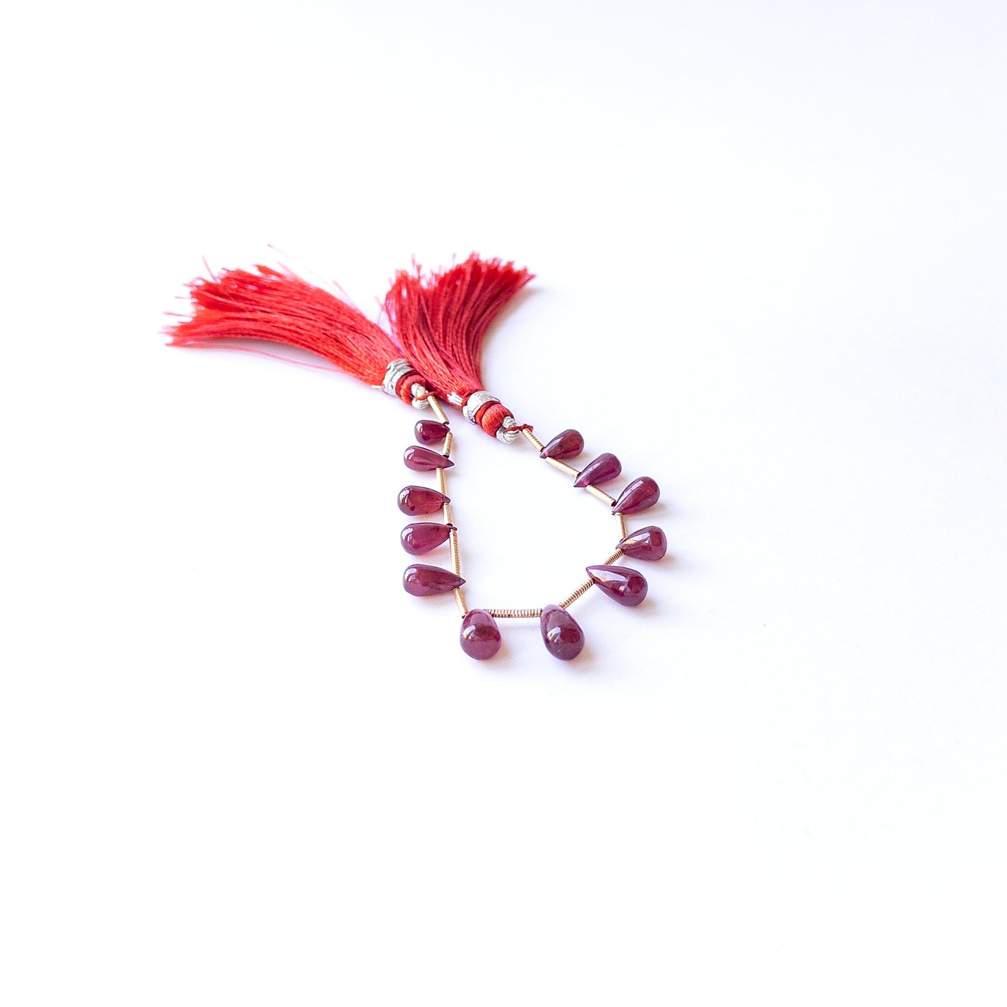 Ruby smooth drop beads in 4.1–5.5mm length and 6–10mm breadth, showcasing genuine gemstone shine for handmade jewellery.