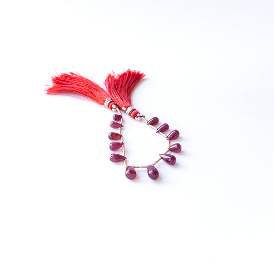 Ruby smooth drop beads in 4.1–5.5mm length and 6–10mm breadth, showcasing genuine gemstone shine for handmade jewellery.