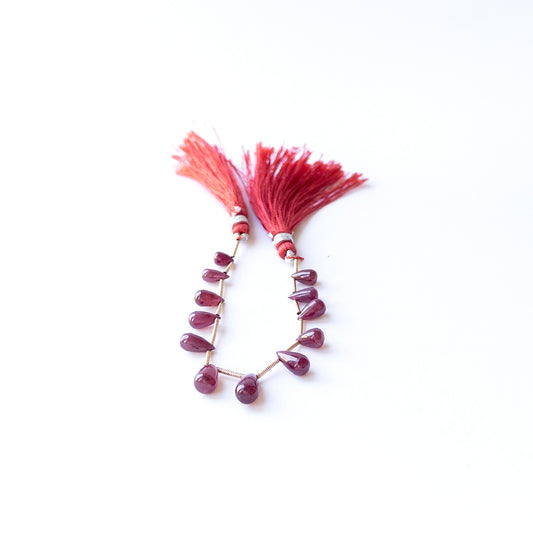 Ruby smooth drop beads in 4.1–5.5mm × 6–10mm size, showcasing genuine gemstone shine for handmade jewellery.