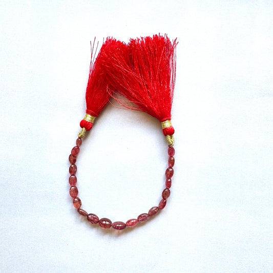 Natural Ruby oval beads displayed in varying sizes, highlighting premium clarity and colour.