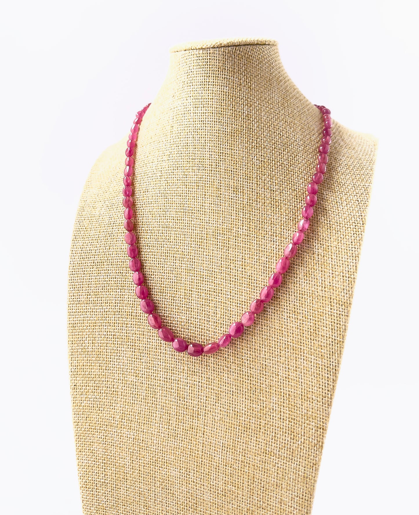 Genuine Ruby smooth oval beads showcasing deep red tones and glossy surfaces in a 182‑carat adjustable necklace.