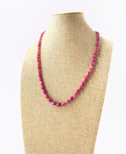 Genuine Ruby smooth oval beads showcasing deep red tones and glossy surfaces in a 182‑carat adjustable necklace.