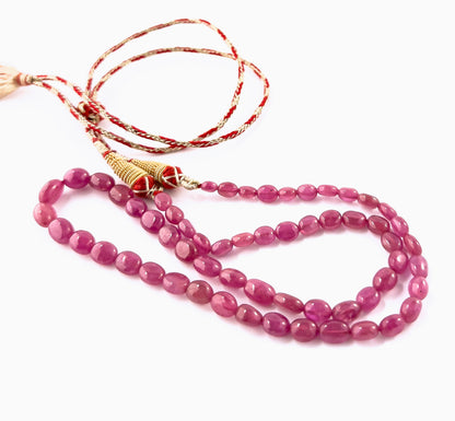 Close‑up of Ruby smooth oval beads highlighting their lustrous finish, organic shape variation and vivid red colour.