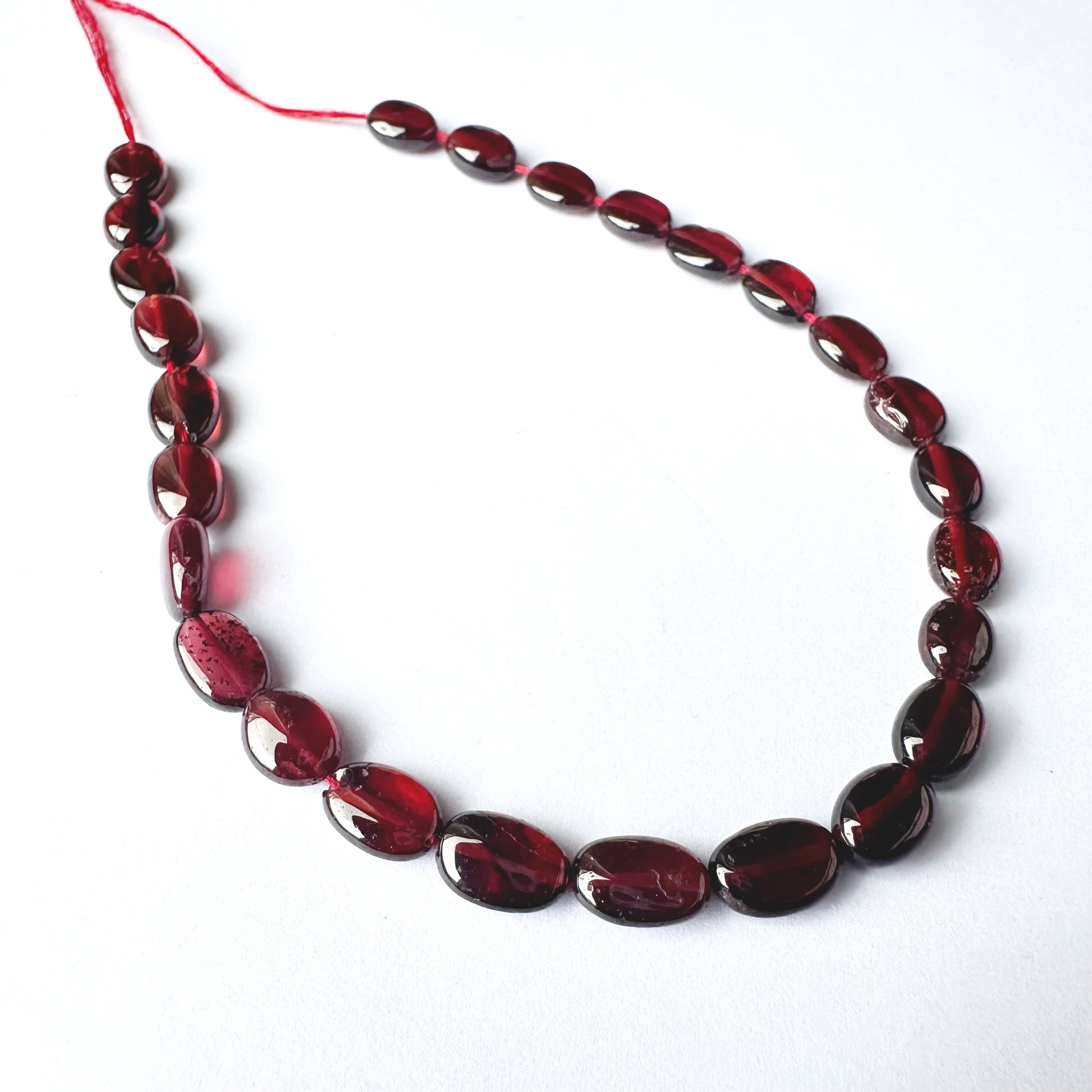 High-quality Ruby ovals with 0.5mm bead holes and vibrant crimson tones.