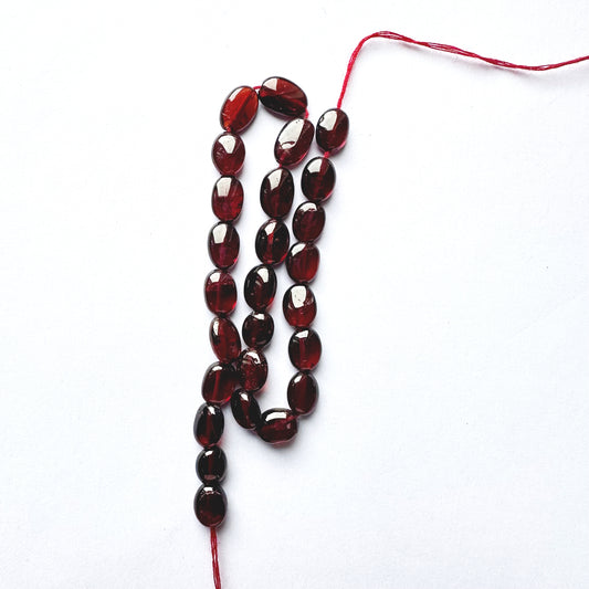 Ruby smooth oval beads with deep red colour and polished 7.5–8.5mm x 6mm finish.