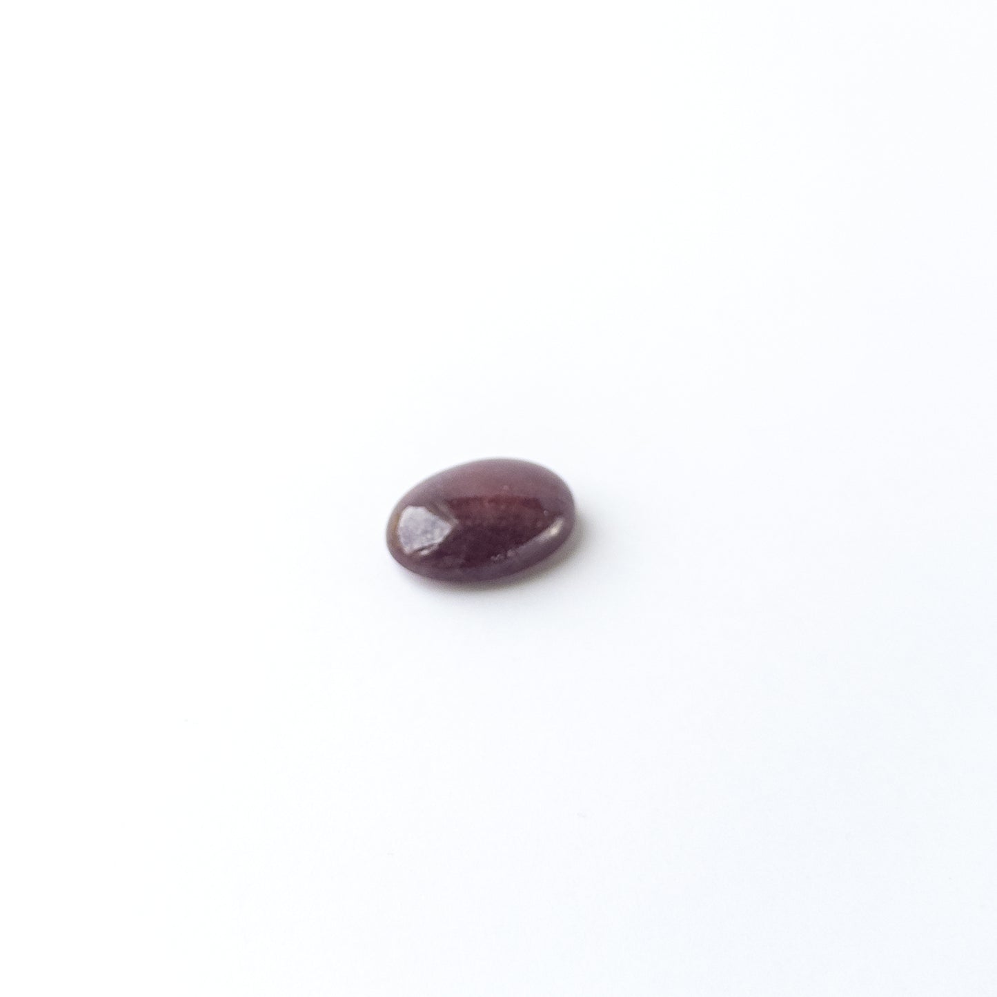 Handmade jewellery components featuring Ruby oval cabochon with polished finish and vibrant red hue.