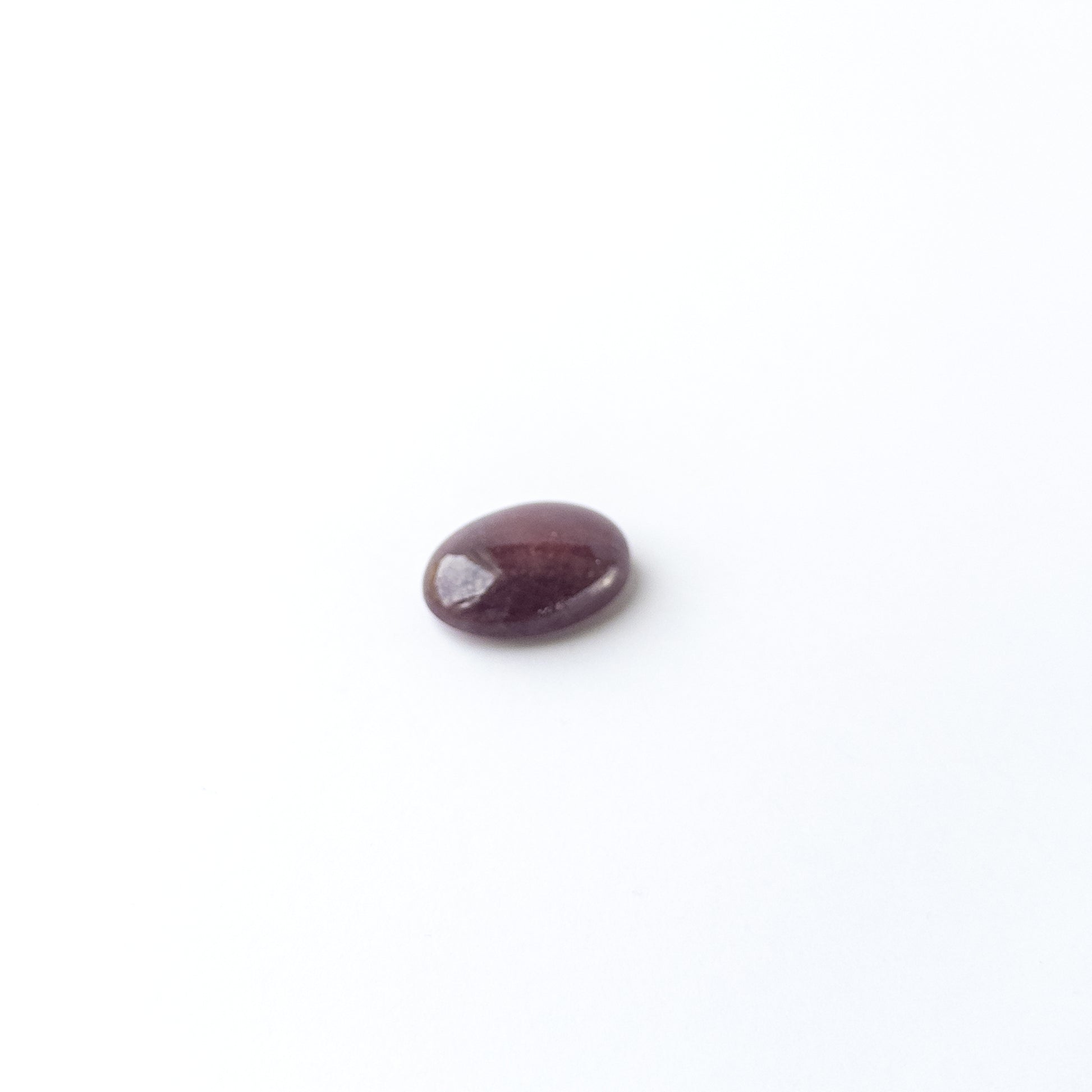 Handmade jewellery components featuring Ruby oval cabochon with polished finish and vibrant red hue.