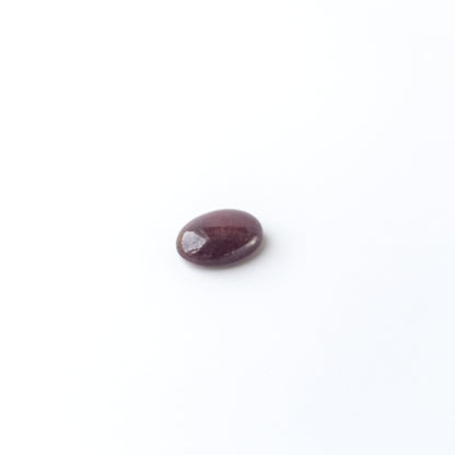 Handmade jewellery components featuring Ruby oval cabochon with polished finish and vibrant red hue.