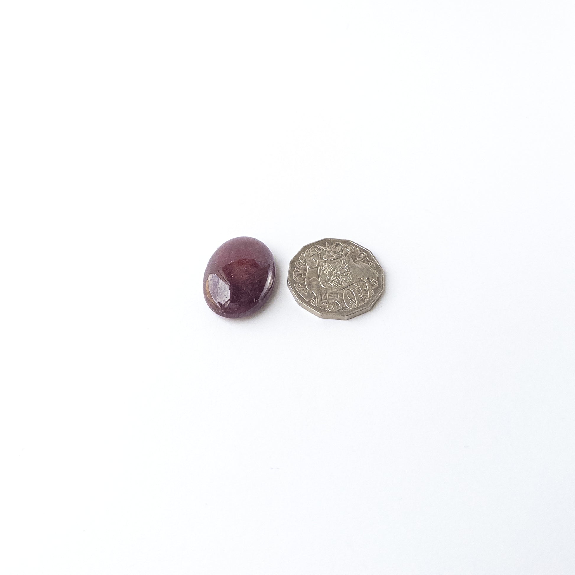 A dial gauge measures the Ruby smooth oval cabochon 31mm × 23mm gemstone.