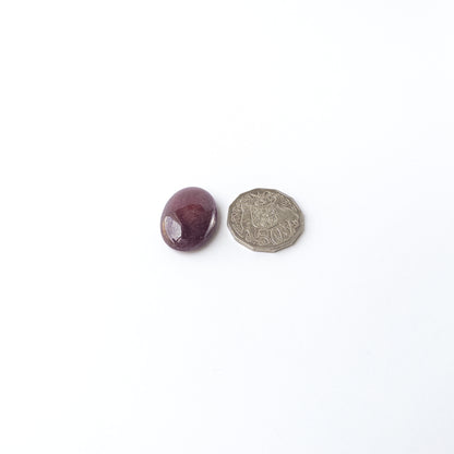 A dial gauge measures the Ruby smooth oval cabochon 31mm × 23mm gemstone.