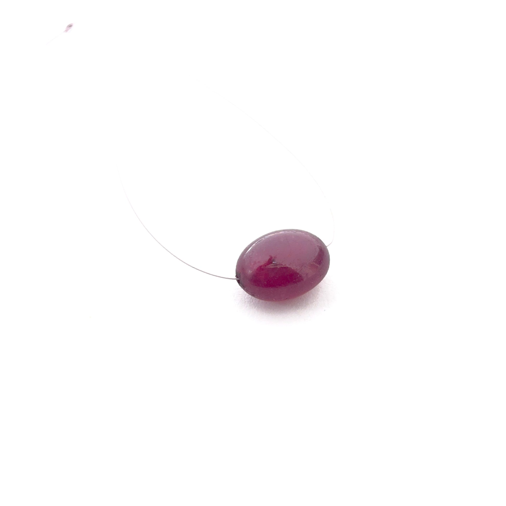 Ruby smooth oval top‑drilled gemstone bead showing rich red colour and polished shine for handmade jewellery.