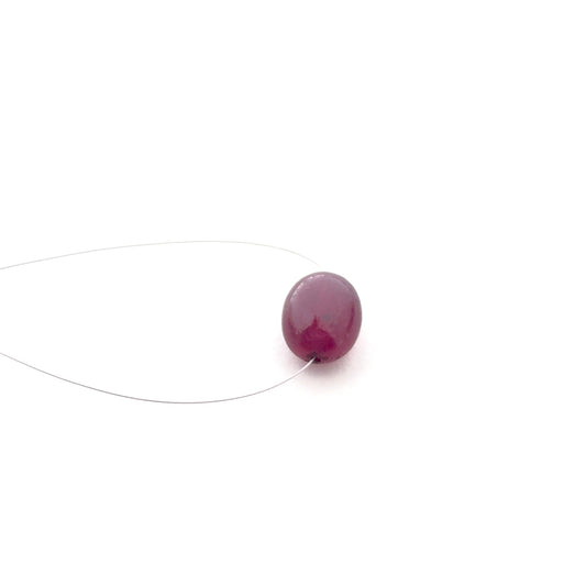 Close‑up of ruby smooth oval stone bead highlighting its deep red tone and glossy surface for DIY jewellery making.