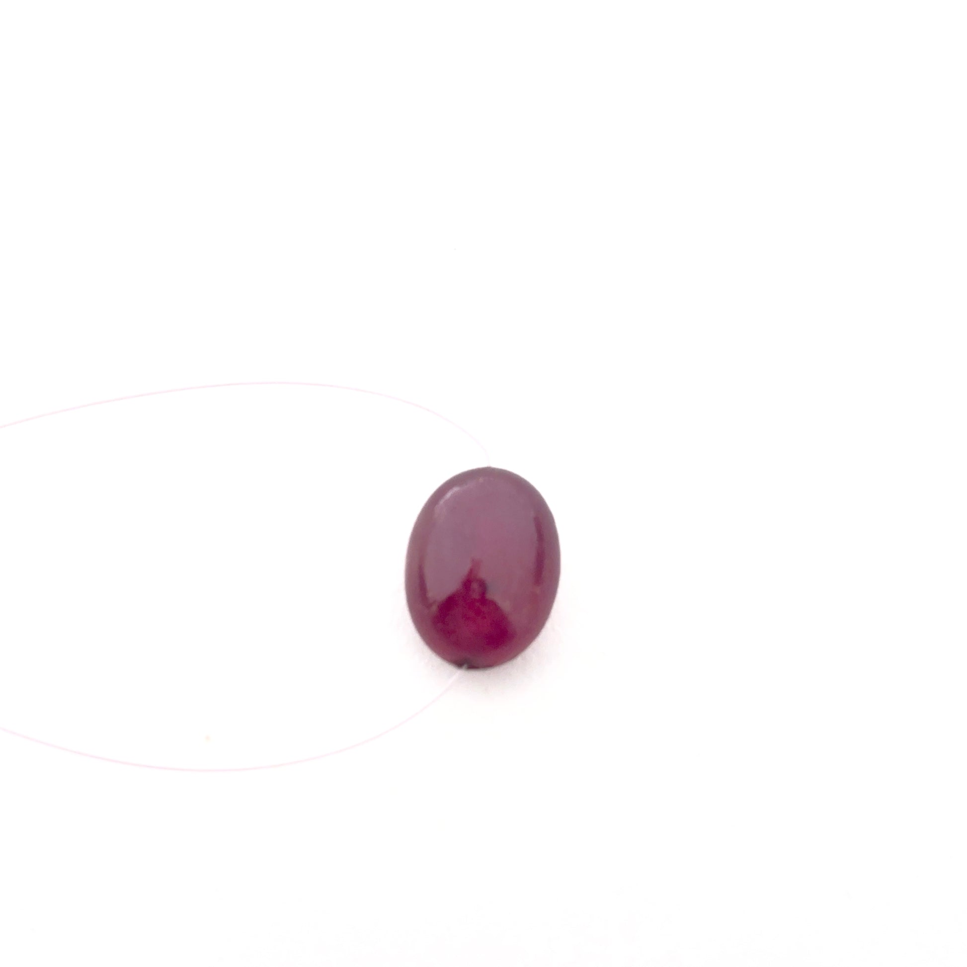 Top‑drilled ruby smooth oval bead displayed with clear detailing, ideal for gemstone beads in jewellery design.