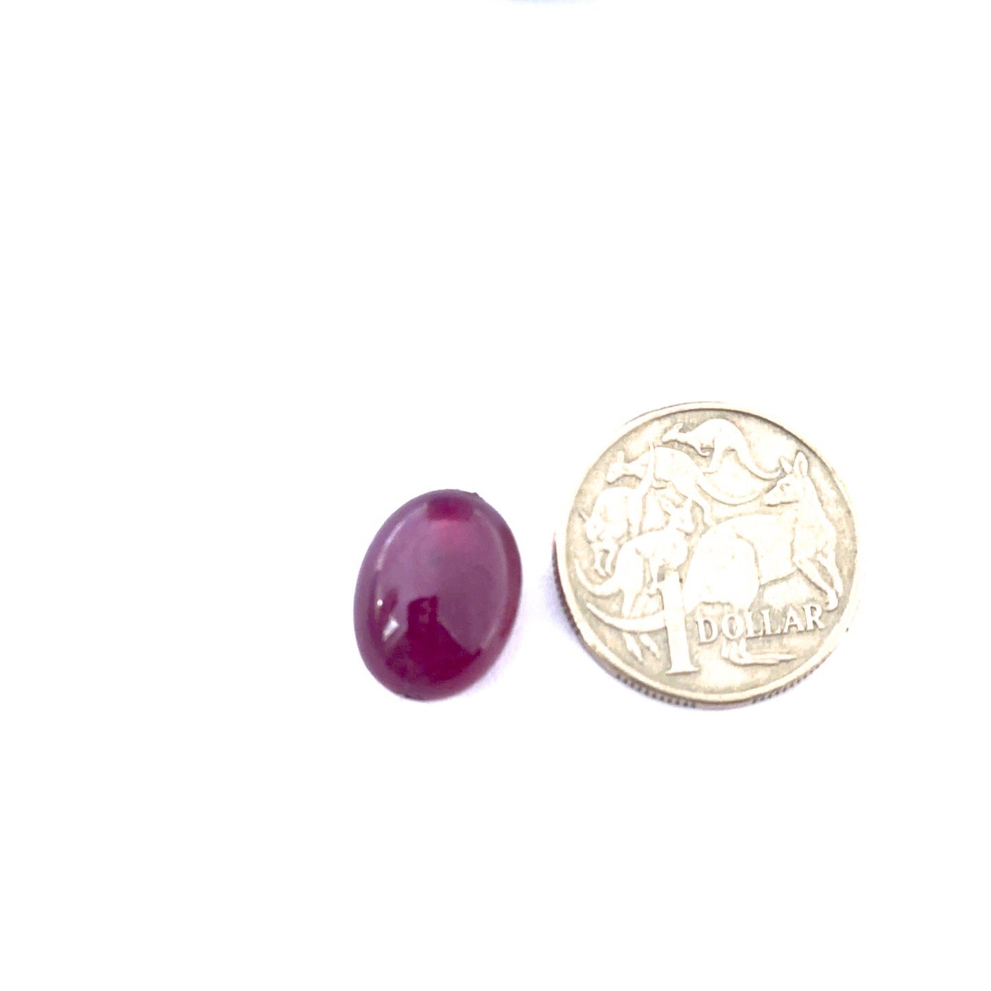 Ruby smooth oval bead photographed to show its polished finish and vibrant colour for handmade jewellery components.