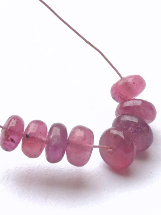 Stone beads arranged to highlight the polished finish and rich ruby colour.