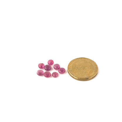 A coin is placed near delicate Ruby beads for scale.