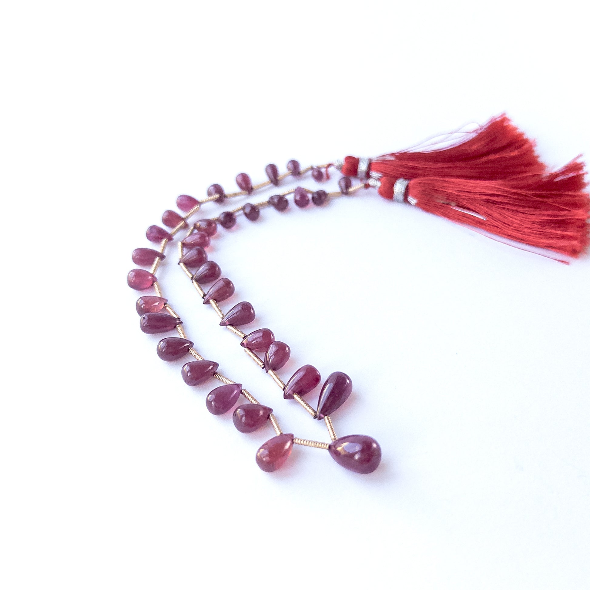 Handmade jewellery components featuring authentic Ruby smooth briolette beads with deep red sparkle.