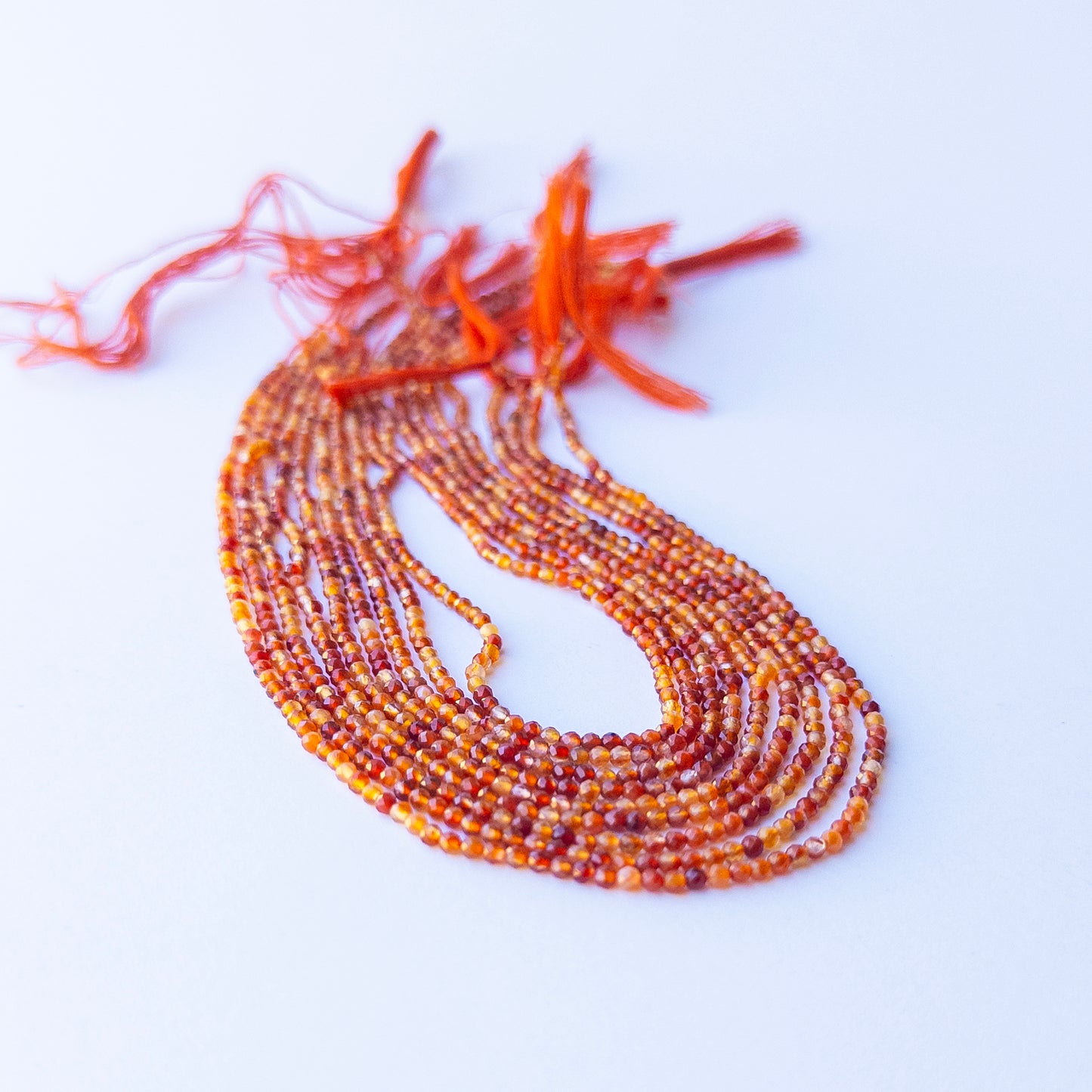 Close‑up of authentic Rutile gemstone beads with faceted rondelle cut, highlighting shine and texture for DIY jewellery makers.