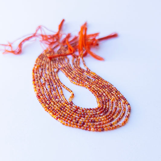 Close‑up of authentic Rutile gemstone beads with faceted rondelle cut, highlighting shine and texture for DIY jewellery makers.