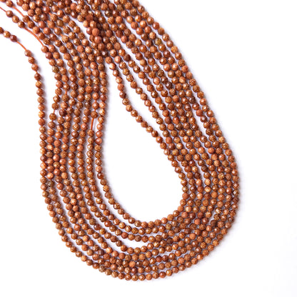 Genuine Sandstone gemstone beads displaying warm golden‑brown tones, polished facets, and a neatly arranged 31cm strand for jewellery design.