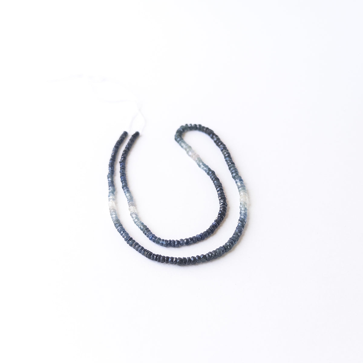Authentic shaded Blue Sapphire gemstone beads displaying crisp faceting and rich tonal variation for DIY jewellery makers.