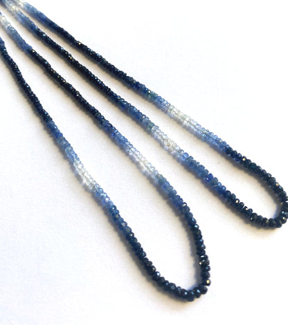 Shaded Blue Sapphire rondelle beads in twilight tones arranged evenly across a 41cm strand.