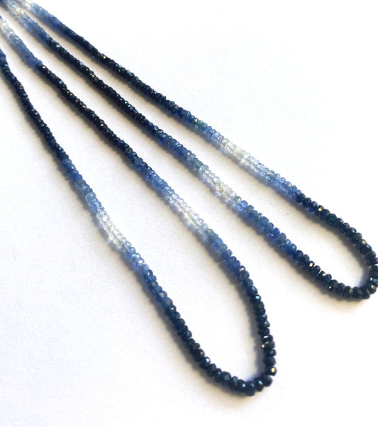 Shaded Blue Sapphire rondelle beads in twilight tones arranged evenly across a 41cm strand.