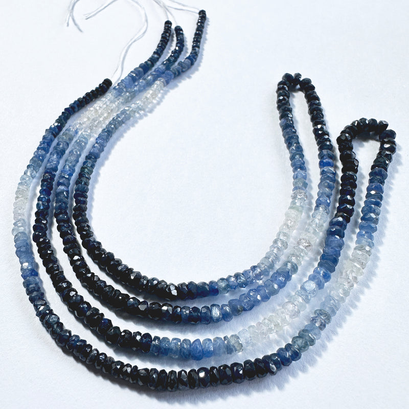 Close-up of 49 carats of shaded sapphire rondelle beads arranged in a smooth, polished 40cm strand.