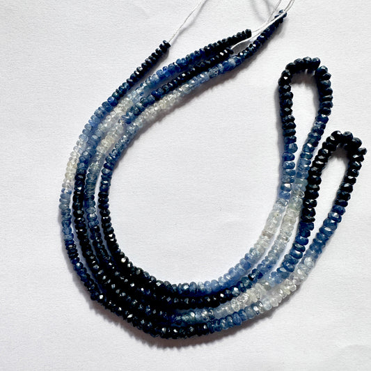 Faceted shaded sapphire beads in a graduated blue arrangement on a jewellery strand.